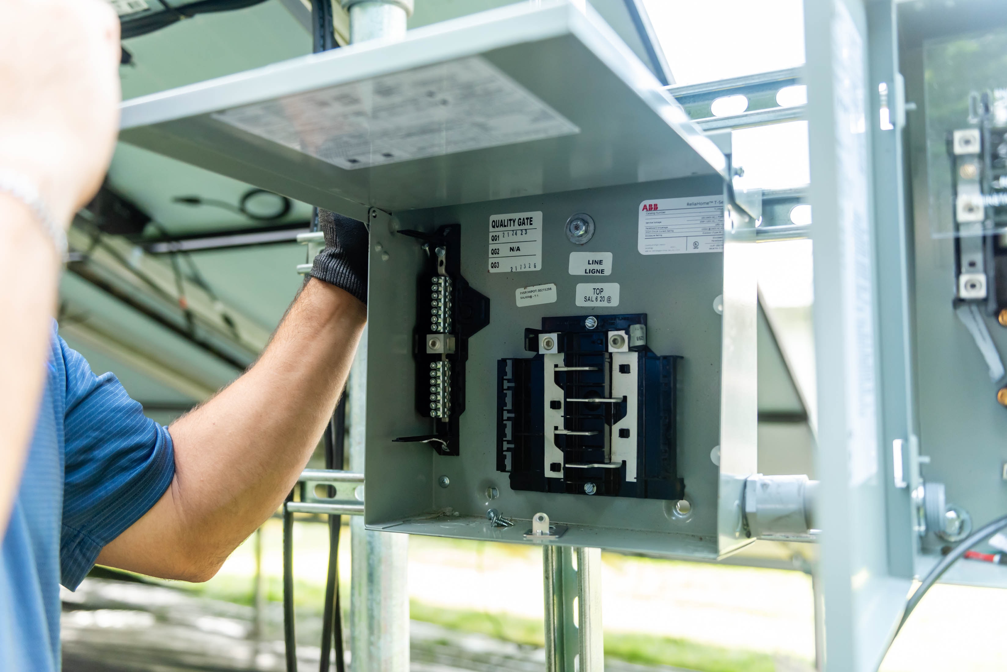 Casta Energy tech opening ABB disconnect panel mounted on solar racking structure
