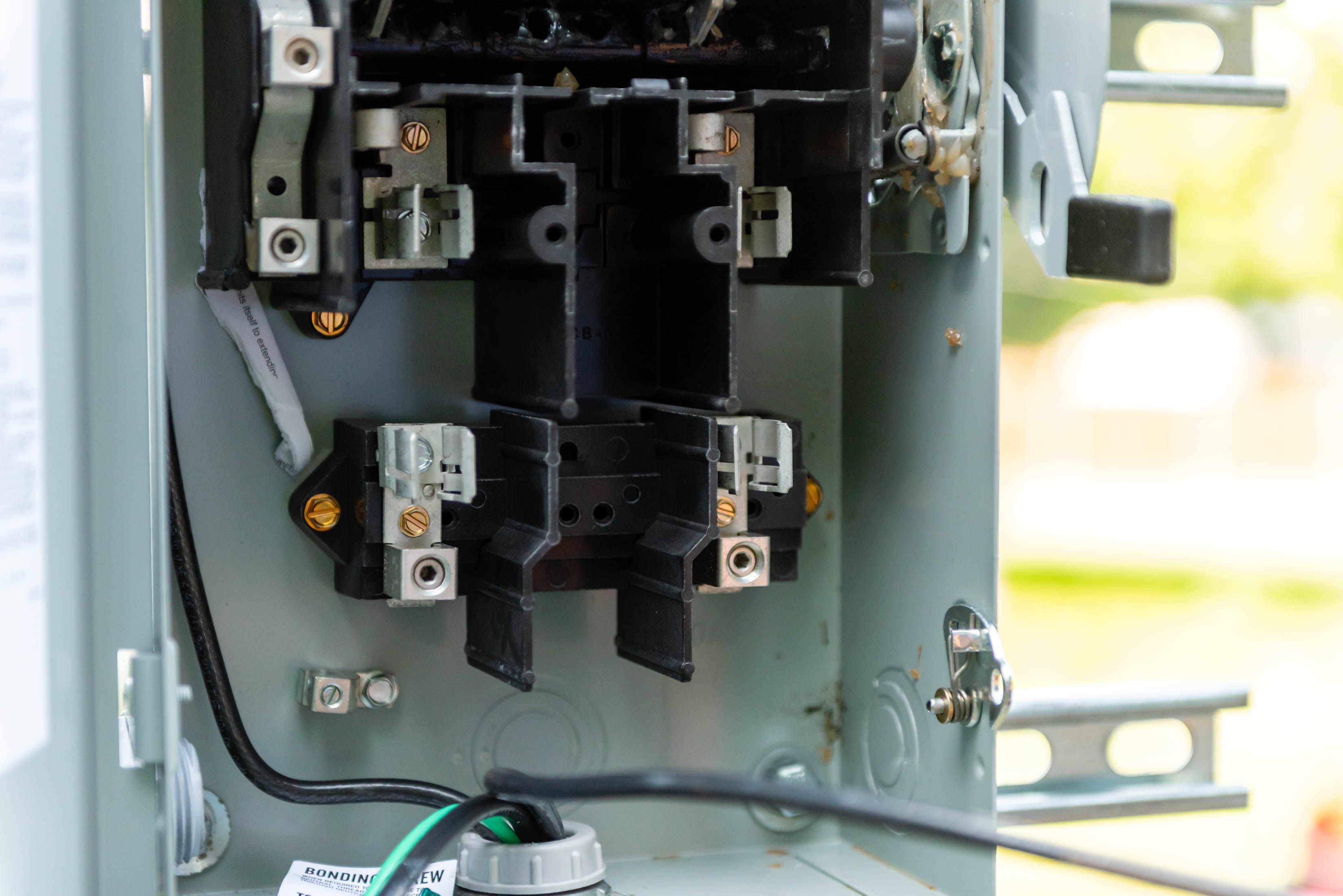 Interior of electrical breaker box during service — Casta Energy