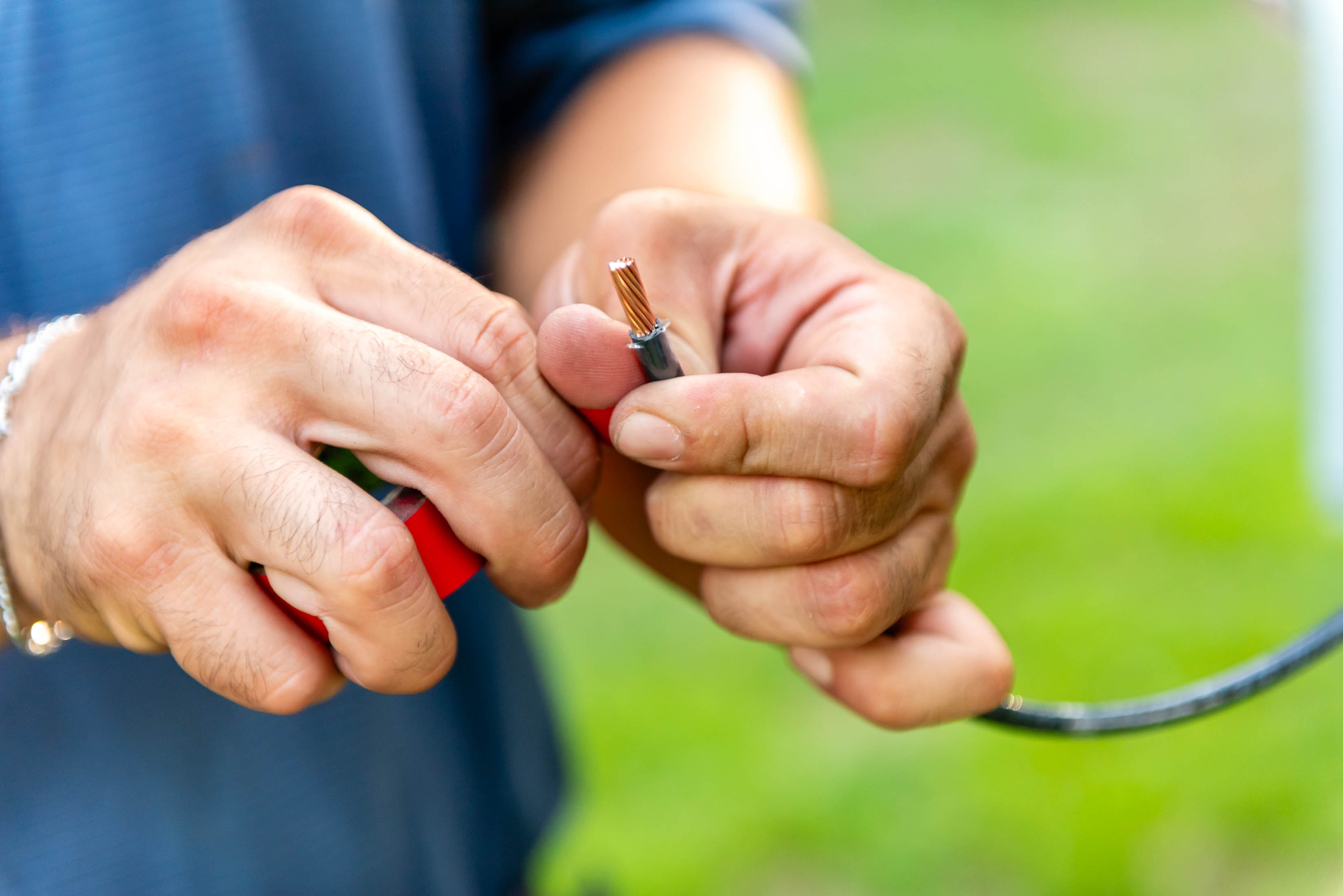 Casta Energy electrician stripping copper wire on the job
