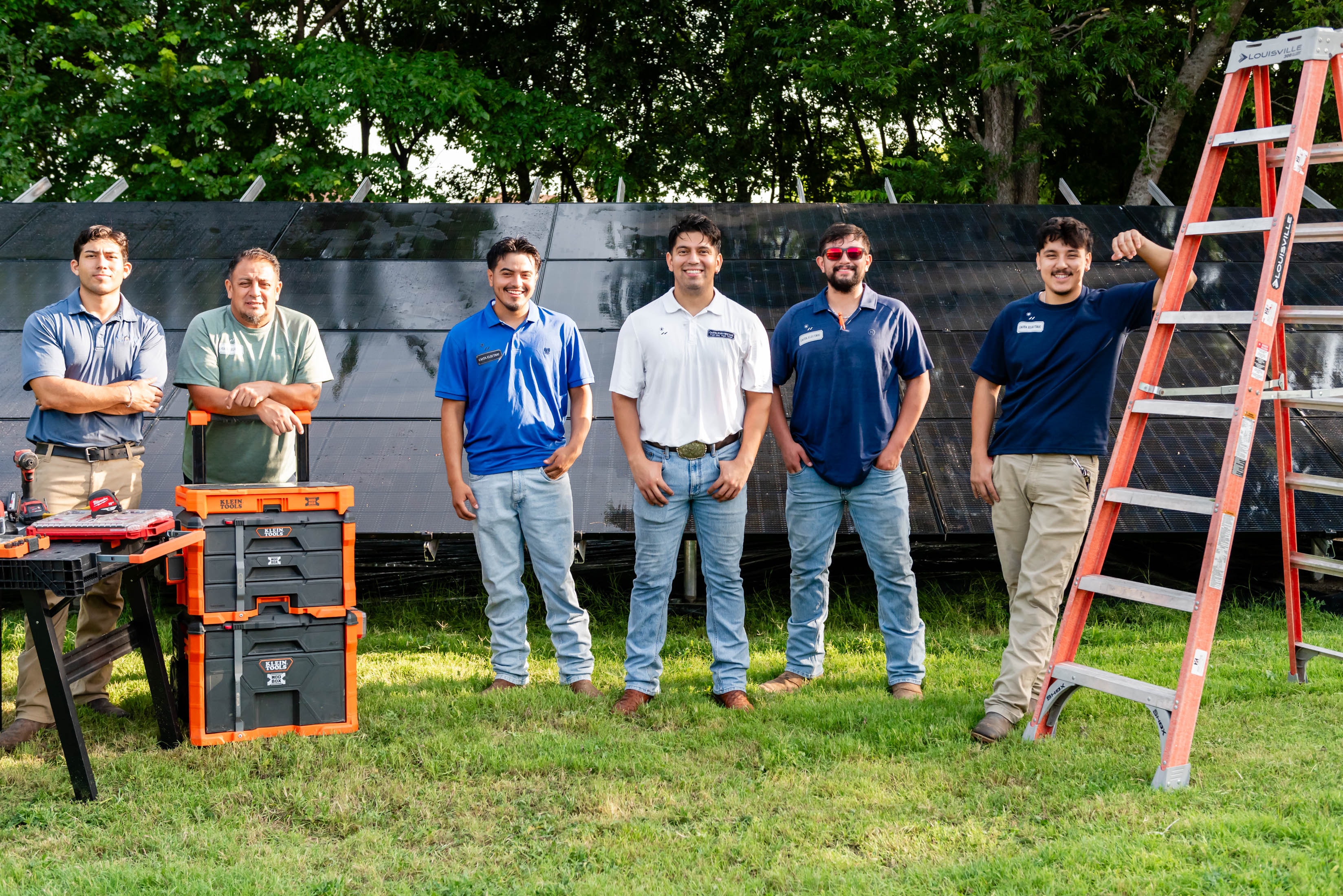 Casta Energy team with Klein Tools boxes in front of solar panels