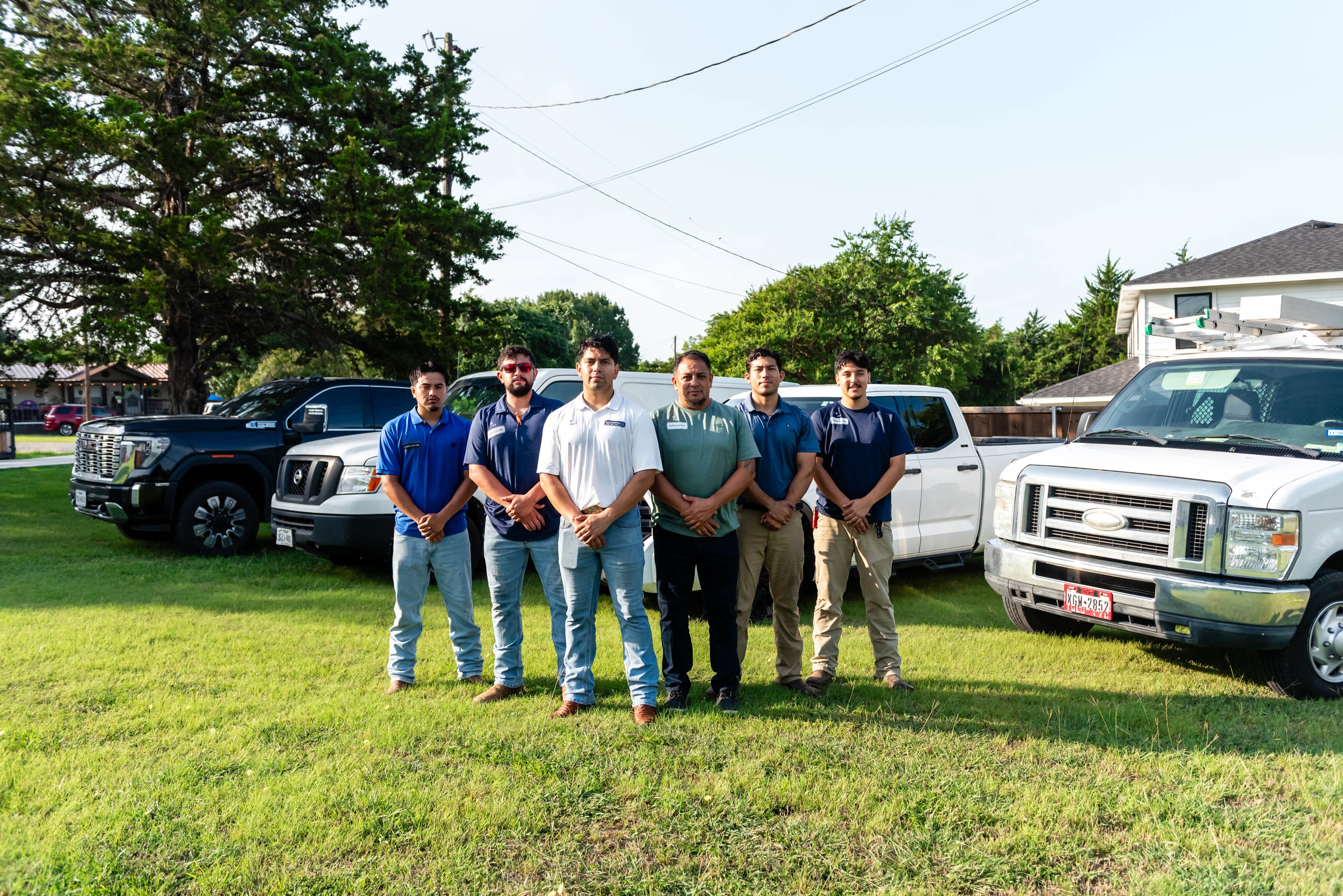 Casta Energy crew standing in front of fleet trucks — DFW electrical contractor
