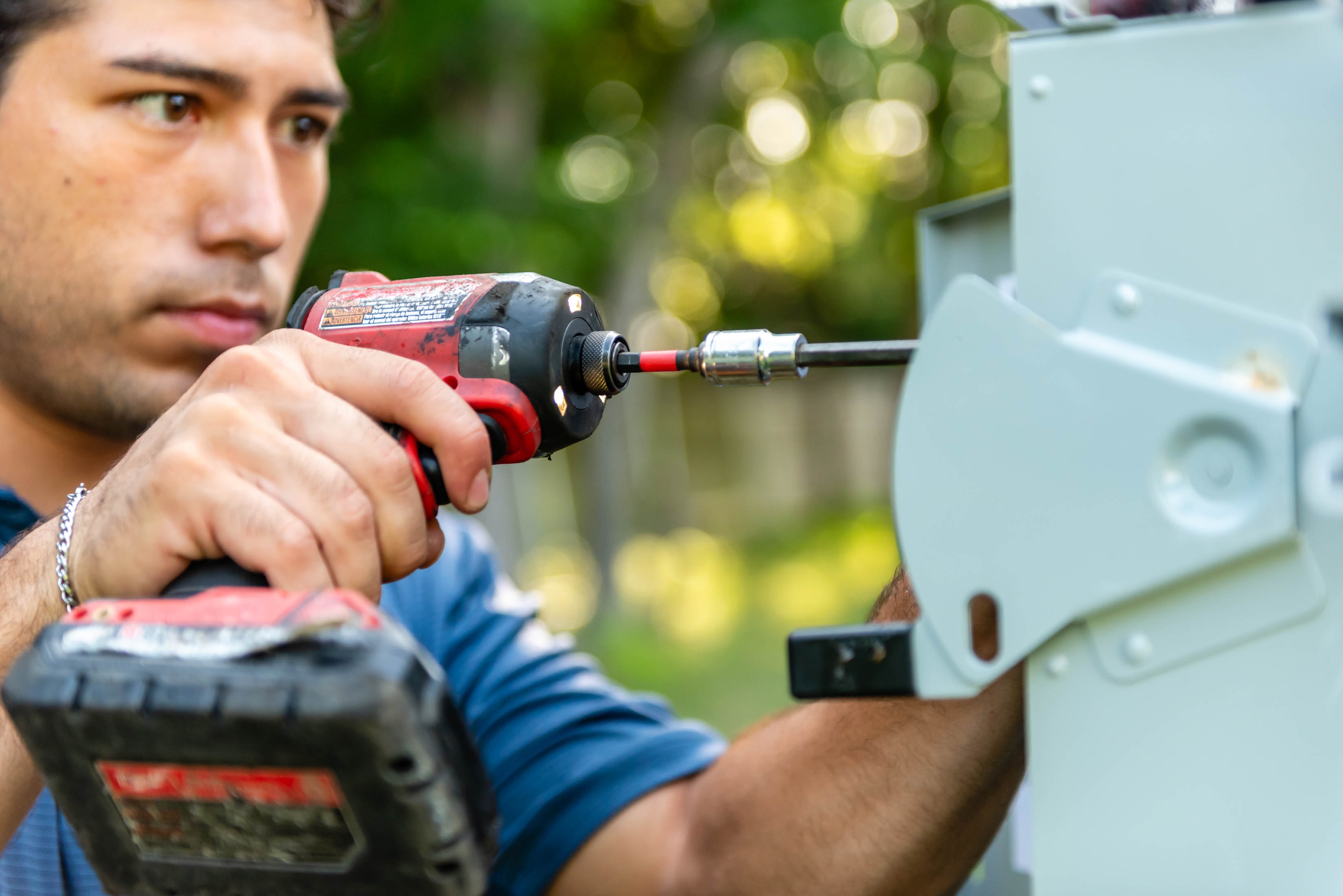 Casta Energy technician drilling into electrical panel enclosure